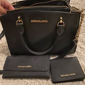 Black Michael Kors purse with matching wallets. Gently used.
